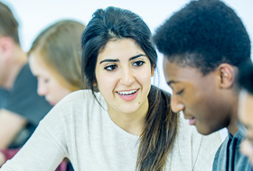 Student and teacher at computer